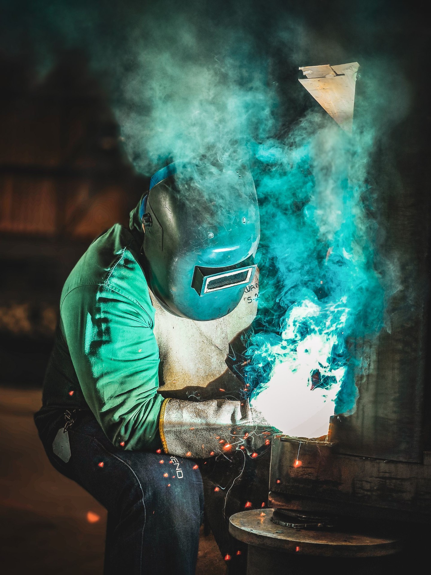 A&R Noble welder striking an arc through a cloud of teal smoke