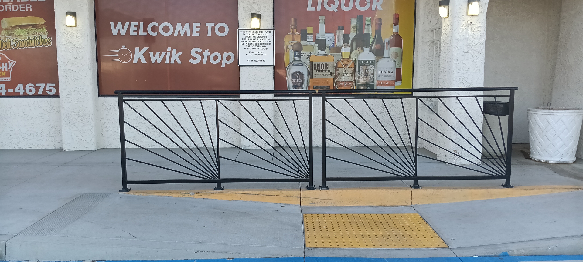 Installed sunburst iron railings at Kwik Stop storefront